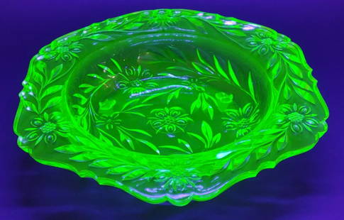 14" Vintage Uranium Glass Footed Bowl: 14" wide uranium green glass footed bowl with branch and floral pattern. Glows bright under uv light.
