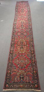 Tabriz Persian Runner Rug 17'4" x 2'9": Measures: 17'4" x 2'9" Hand knotted Tabriz Persian runner rug. Wool pile. Colors: Red, black, blue, yellow, beige. Fringe ends. Very vibrant colors with a high level of floral details.