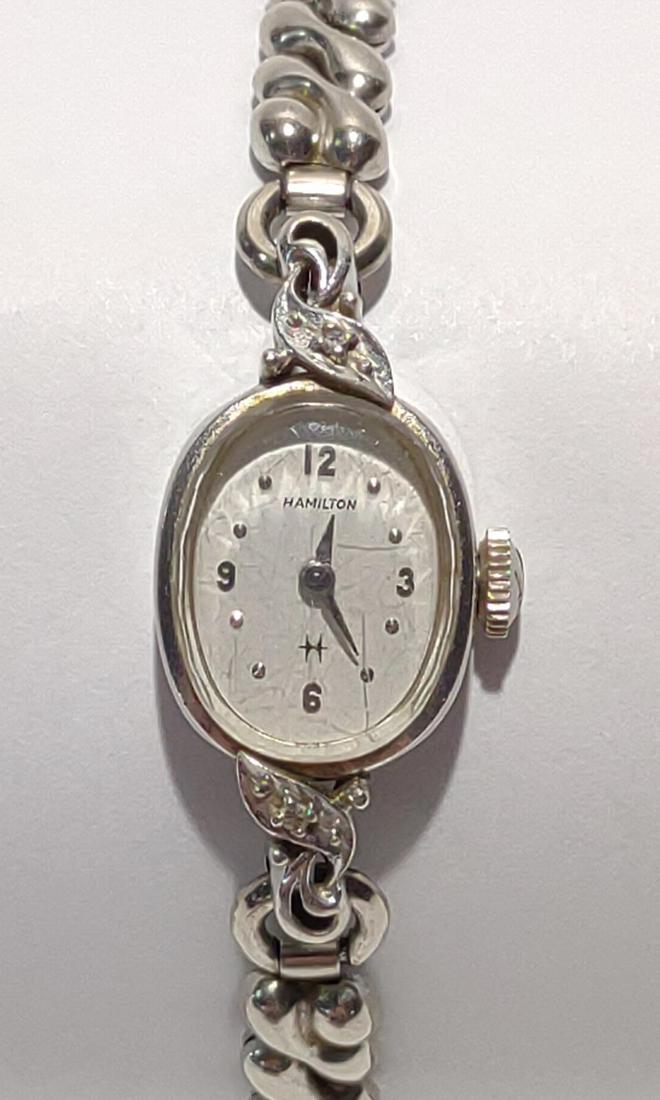 10K Gold Hamilton Ladies Wrist Watch (Works): 10 karat white gold Hamilton ladies watch case with vintage Speidel band (band is not gold). Back of watch case is marked '10K Gold'. Tested and works. Tested for gold purity.
