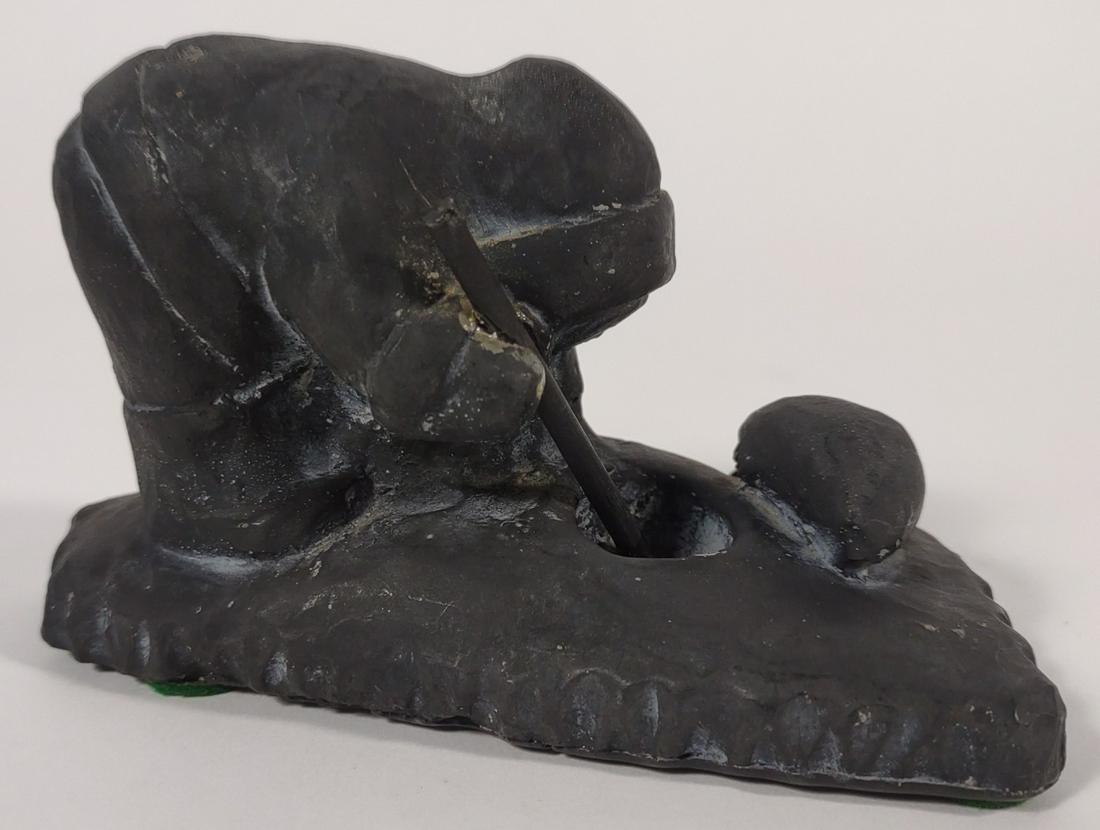Inuit Sculpture of Hunter & Seal: Depicts hunter figure looking through ice hole with spear and seal laying on ice. Cast sculpture made to imitate soapstone. No marks on underside.