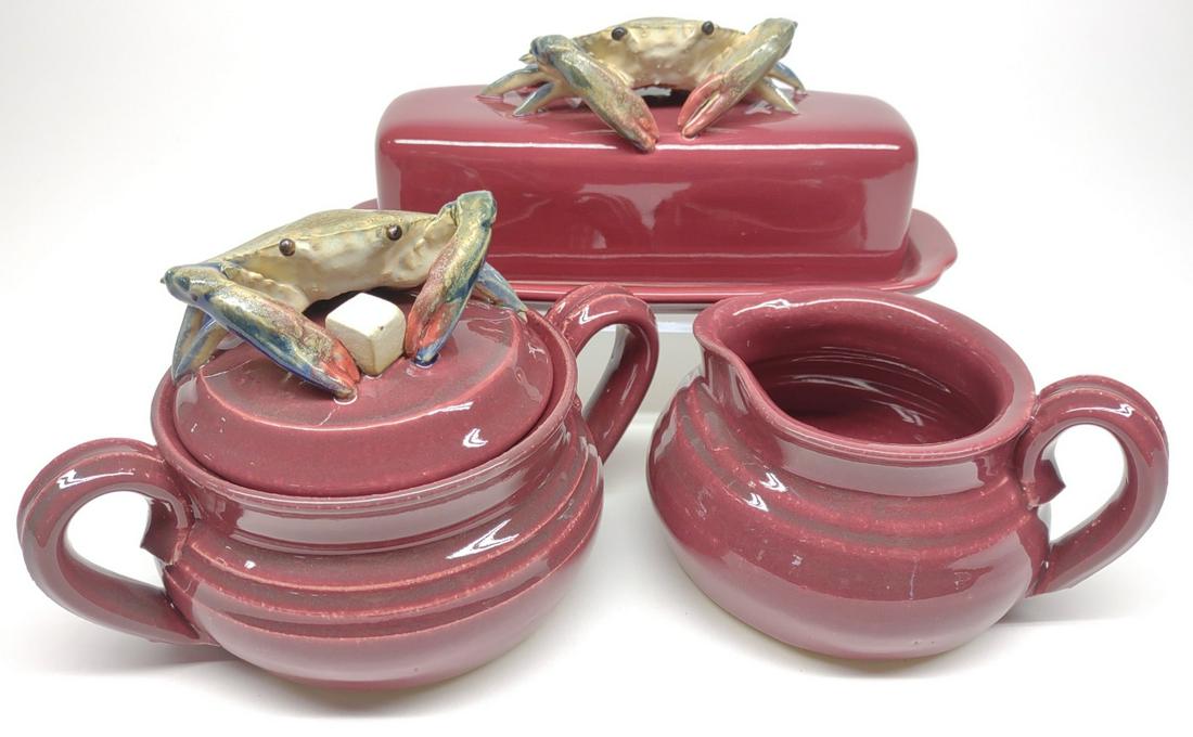 3 pc Signed Crab Pottery Studio Art Serveware: Set of 3 artist signed studio pottery art pieces with sculpted Chesapeake blue crabs, glazed with burgundy red. Underside of each is signed "ASH". Includes lidded butter tray, lidded sugar, and creame