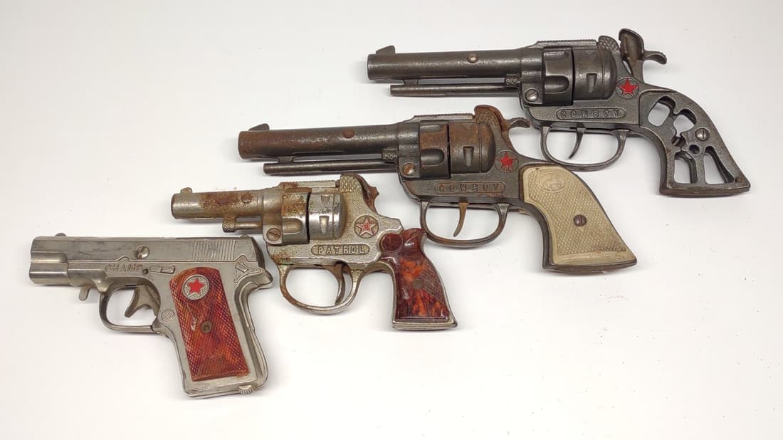 4 Vintage Hubley Toy Cap Guns: Includes pair of early Hubley western cowboy toy cap gun revolvers, Hubley patrol toy cap gun, and Hubley Champ toy cap gun.