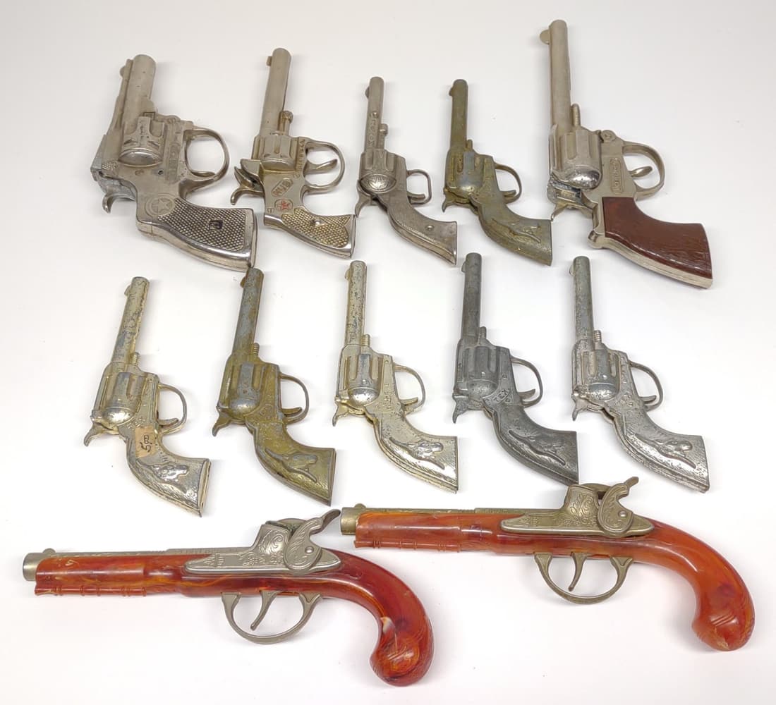12 Vintage Hubley Toy Cap Guns & Revolvers: All are made by Hubley. Includes 7 "tex" metal toy revolvers, Hubley trooper cap gun, Hubley Cowpoke cap gun, 2 hubley flintlock jr toy pistols, and Hubley star revolver toy.