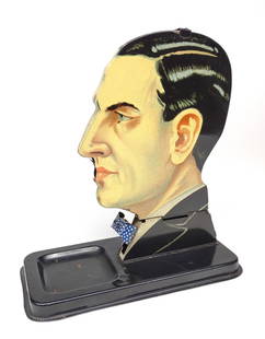 1920s Tin Mechanical Gentleman Cigarette Dispenser: A tin litho mechanical gentlemans head cigarette dispenser. Circa 1920s, vintage. Made by the toy company Georg Kellermann. Very good, working condition. Press down his tie, and a cigarette pops out.