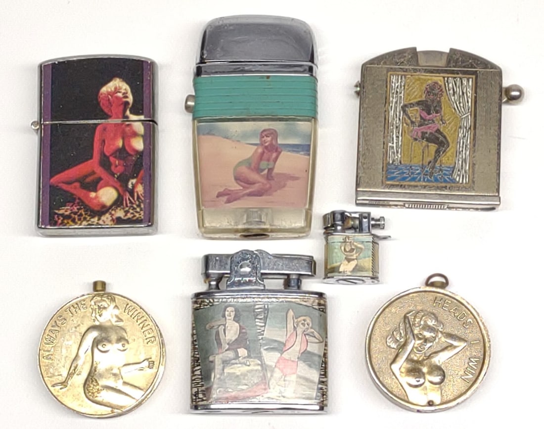 7 Pin-up & Nude Cigarette Lighters: A group of 7 vintage bathing suit, pin-up, and nude lighters. Includes miniature japan bathing beauty lighter, Atlantis Japan bathing beauties lighter, Scripto Vu Lighter, Nude Penguin Lighter, Kay-Es