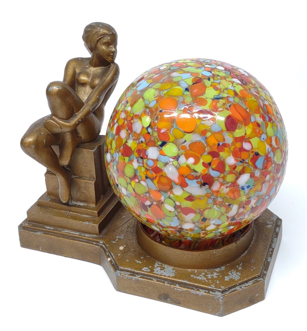 Art Deco Figural Nude Table Lamp (Works): A vintage, art deco era, spelter metal table lamp of nude female sitting on pedestal next to multicolored glass globe lamp shade. Working condition. No makers marks.
