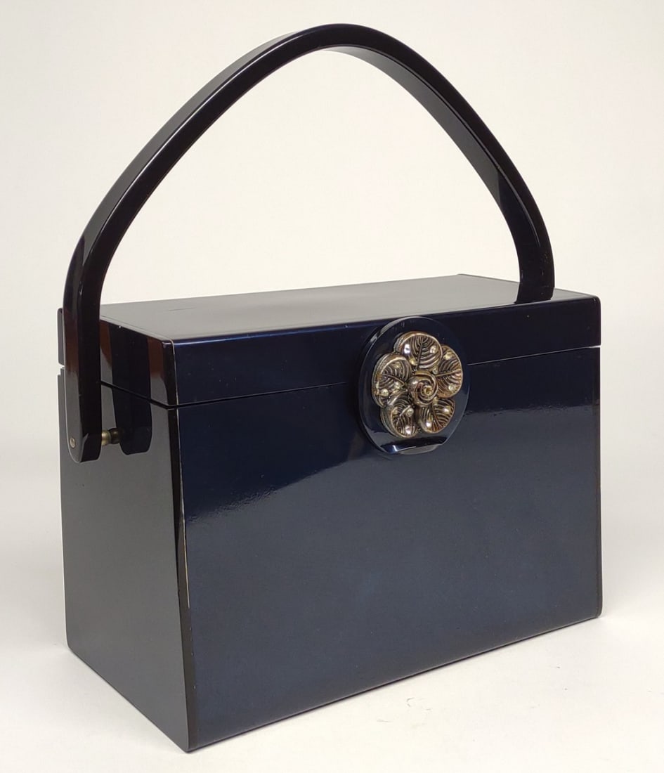 Vintage Wilardy Lucite Box Purse: A vintage navy blue lucite purse by Wilardy. Interior is marked "Wilardy". Inner lid is a full mirror. Back bottom edge has separated slightly (refer to photos).