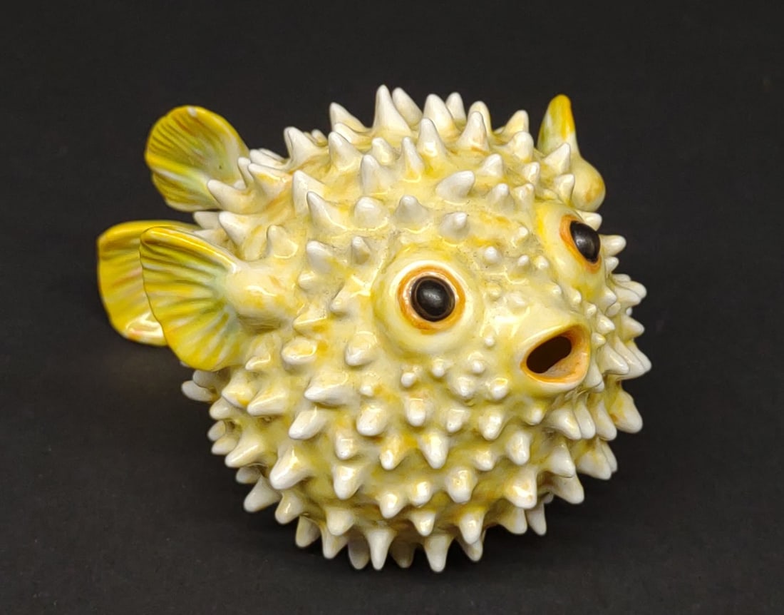 Nymphenburg Blowfish Porcelain Figure (Hedgehog): A Nymphenburg porcelain hedgehog "Igelfisch" fish figurine / sculpture. In yellow. Makers mark on underside. Figure Designed by Luise Terletzki-Scherf , 1958. 2 1/2" tall. Current retail price $1,978.