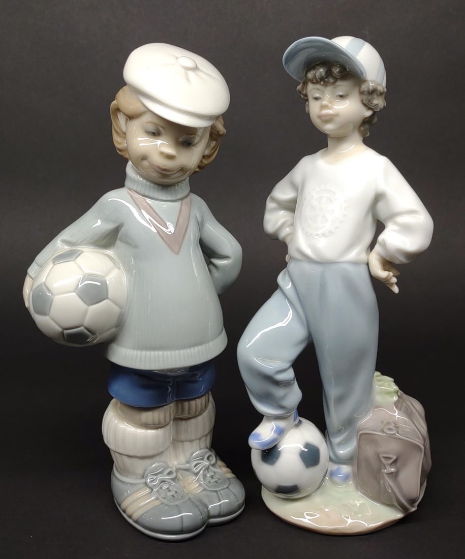 2 Lladro Soccer Porcelain Figures (#4967 & 7605): 2 porcelain Lladro soccer playing boy figurines. Includes #4967 (Soccer player puppet) and #7605 (Starting Forward). Both are in excellent condition with no chips or cracks.In-house International ship