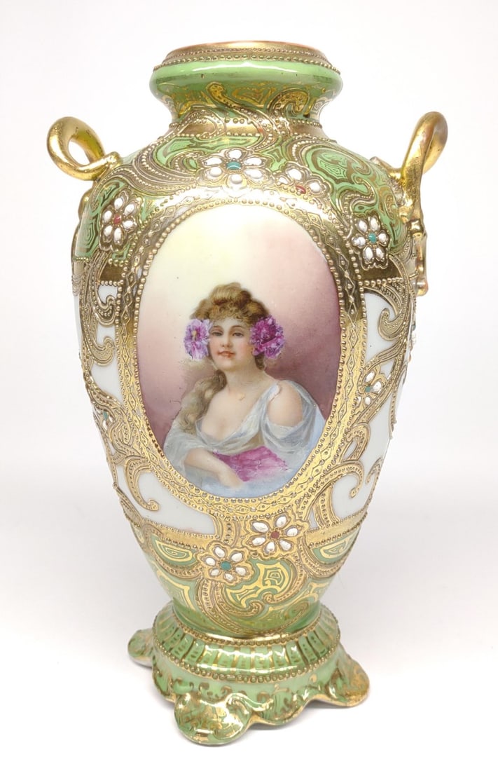Nippon Portrait Of Woman Jeweled Urn Vase: Antique, circa late 19th/early 20th century, hand painted porcelain Japan Nippon double handled urn vase. Features a portrait of a woman with gold beading, and enamel jeweling. Painted against and whi