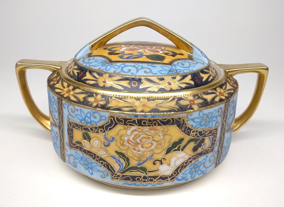 Nippon Blue & Gold Floral Cracker / Biscuit Jar: Antique, circa late 19th/early 20th century, hand painted porcelain Japan Nippon lidded cracker / biscuit jar. Featuring floral painted scroll details on yellow background with bright blue base and go