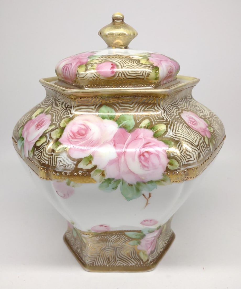 Nippon Pink Rose Floral Biscuit / Cracker Jar: Antique, circa late 19th/early 20th century, hand painted porcelain Japan Nippon biscuit / cracker jar. Featuring pink rose flowers with gold patterns throughout, and raised gold beading. Jar stands 7