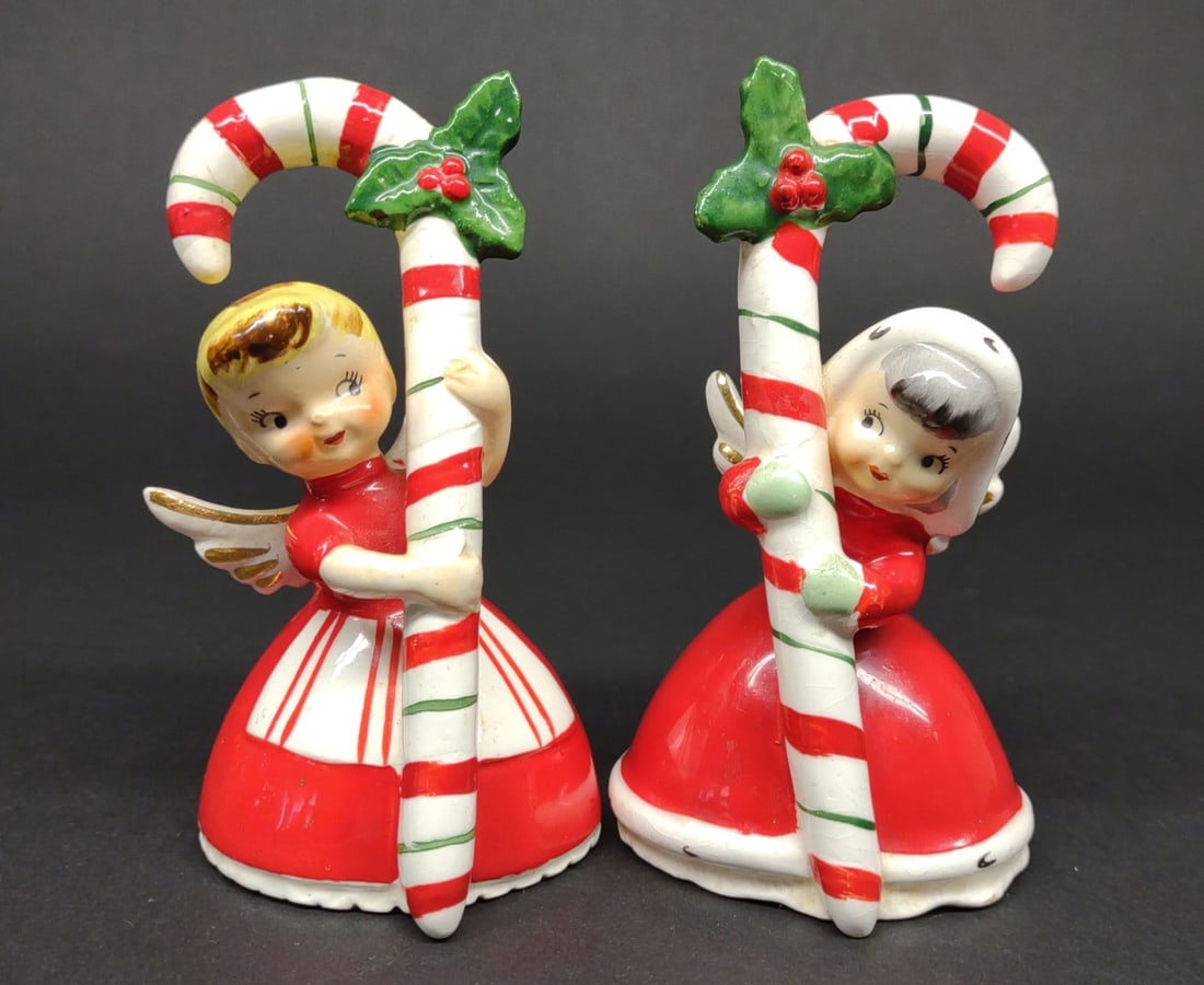 (2) 1956 Japan Angel Candy Cane Bell Figurines: (2) Vintage 1956 made in Japan Napco ceramic candy cane angel bells Christmas figures. Condition: Repair to 1 wing on each.