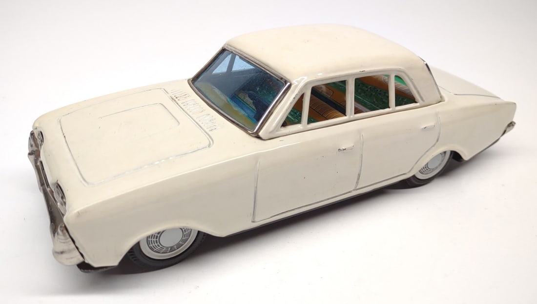 Bandai Japan White Ford Taunus Tin Friction Toy: Vintage Japan (Bandai) tin litho white Ford Taunus friction powered toy car. Marked on underside with bandai makers mark. Friction drive tested and working. Car measures approximately 8.25" long.