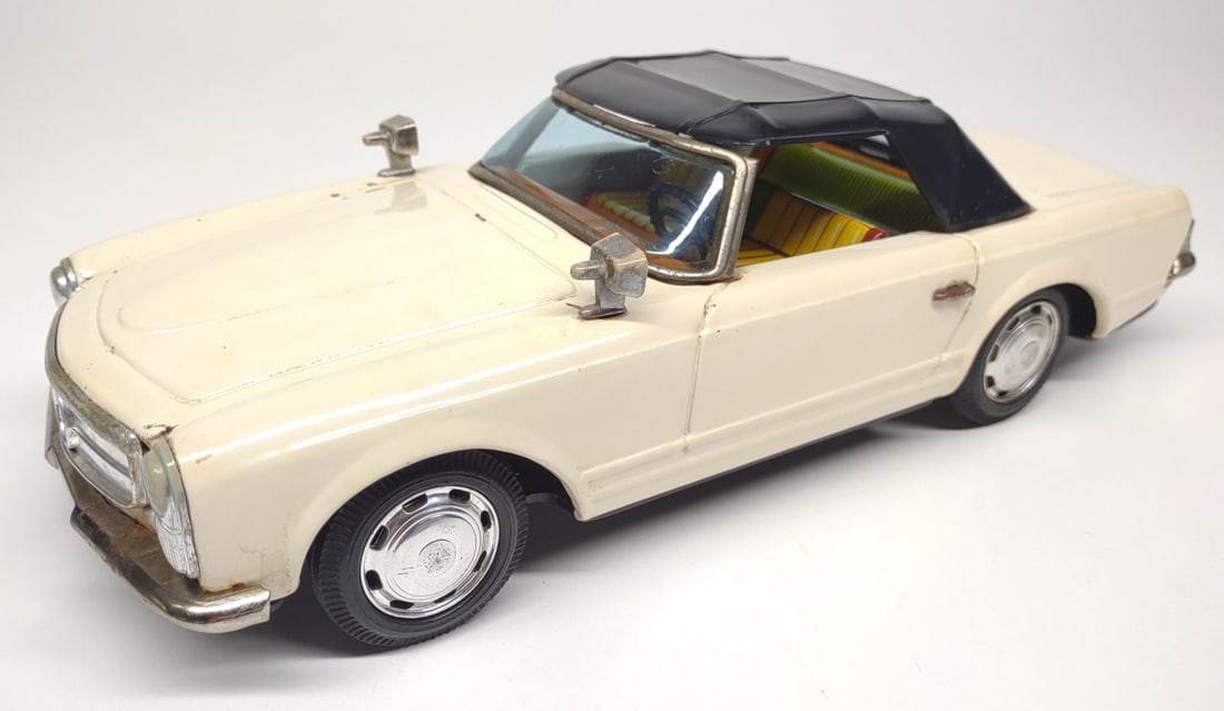 Bandai Japan Mercedes Benz 250SL Friction Car: Vintage tin litho Japan (Bandai) white Mercedes Benz 250SL friction toy car. Bandai makers mark on underside. Friction drive tested and working. Measures approximately 10" long.