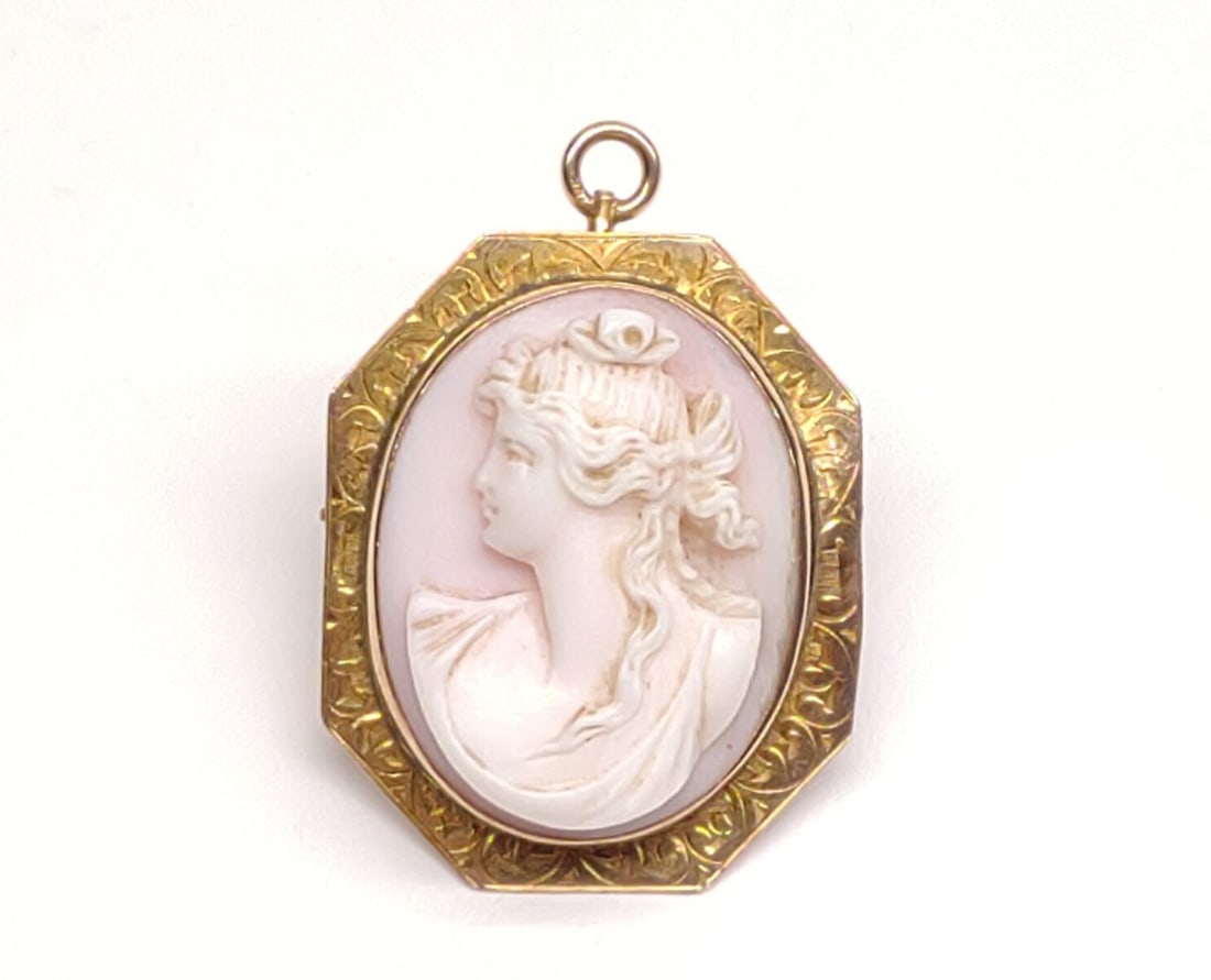 Vintage 10K Gold Carved Cameo Brooch / Pendant: A vintage 10 karat yellow gold carved cameo shell brooch with hinged necklace pendant loop. Marked "10K". Has been tested for gold purity. Total Weight: 5.43 grams.