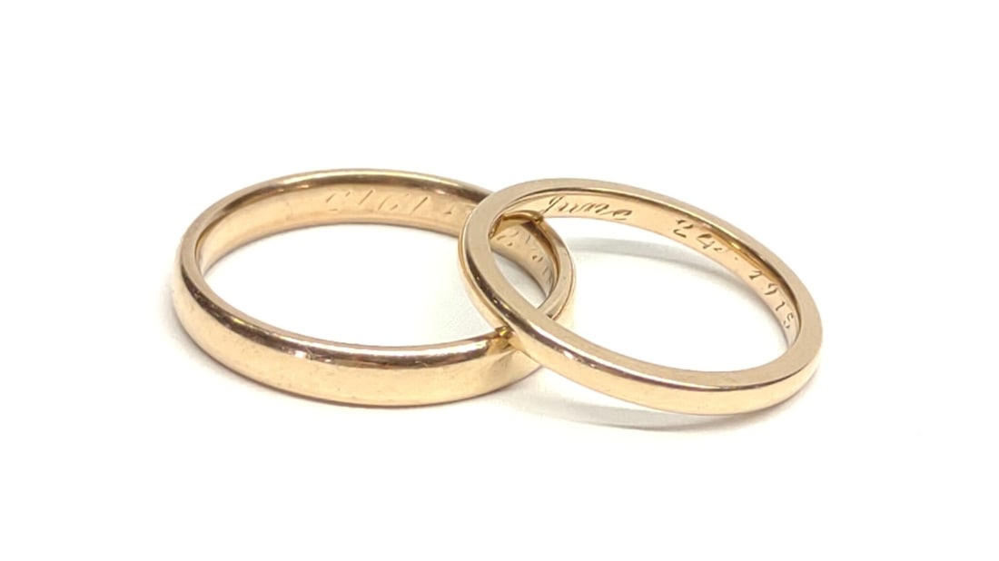 Pair of 1915 14K Gold Wedding Band Rings: A pair of antique, dated 1915, 14 karat yellow gold wedding band rings. Inner band is inscribed with marriage initials and dated 1915. Both are marked "14K" and have been tested for purity. Wider band