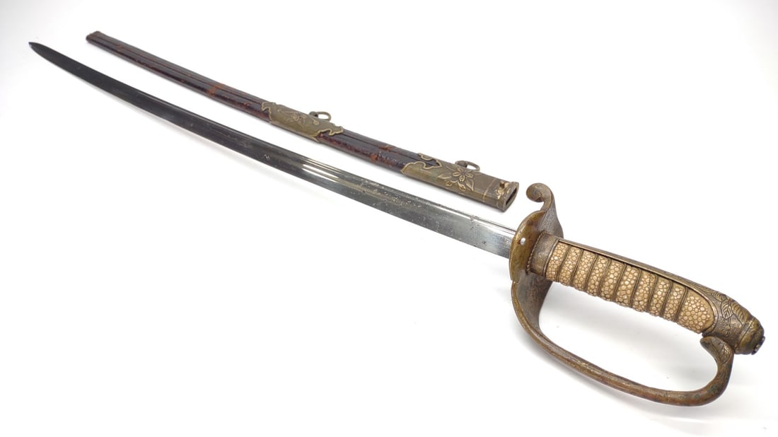 WWII Imperial Japan Navy Officer Sword & Scabbard: WW2 Imperial Japanese Model 1883 Kyo-Gunto naval officers dress sword and scabbard. No distinguishable markings present. End of leather sheath is missing. Blade measures approximately 26.25" long. Swo