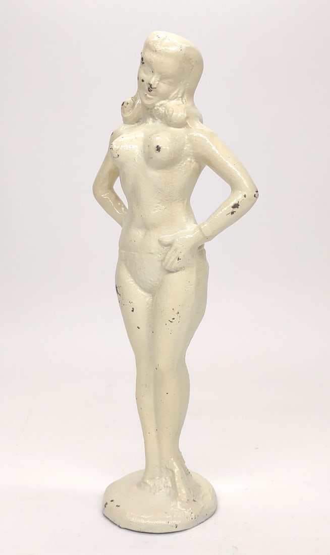 Art Deco Cast Iron Nude Woman Sculpture / Doorstop: A vintage, art deco era, cast iron painted risque figure of a topless nude woman with hands on hips. Circa 1930s-40s. Measures 5" x 3" x 11.75". Includes provenance note expressing that this figure wa