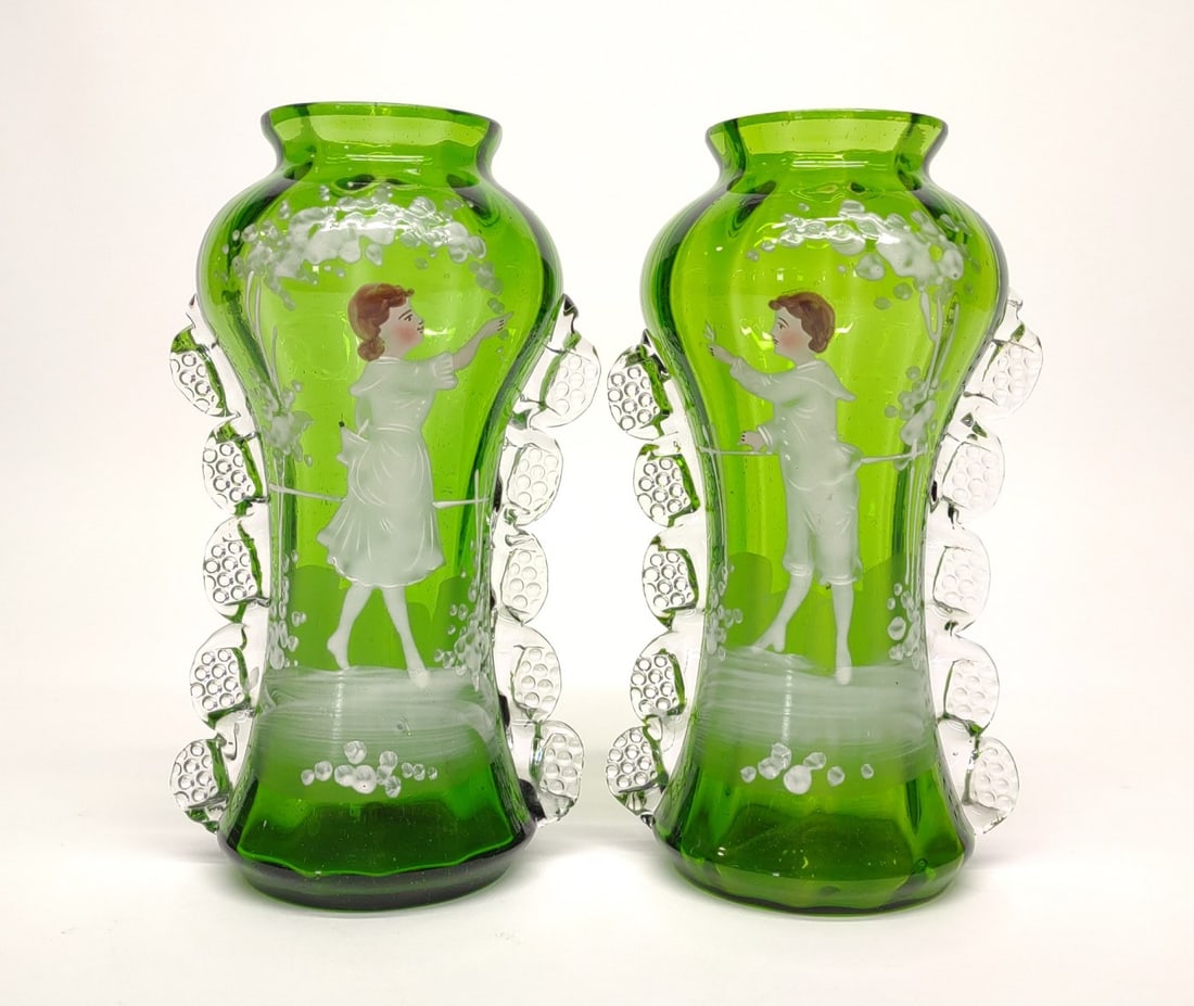 Pair of Mary Gregory Victorian Painted Glass Vases: A pair of antique, Victorian hand painted Mary Gregory green glass mantle vases. Decorated with a boy and girl. Good condition with no chips or cracks. Stands 6.75" tall.NOTE: In-house international s