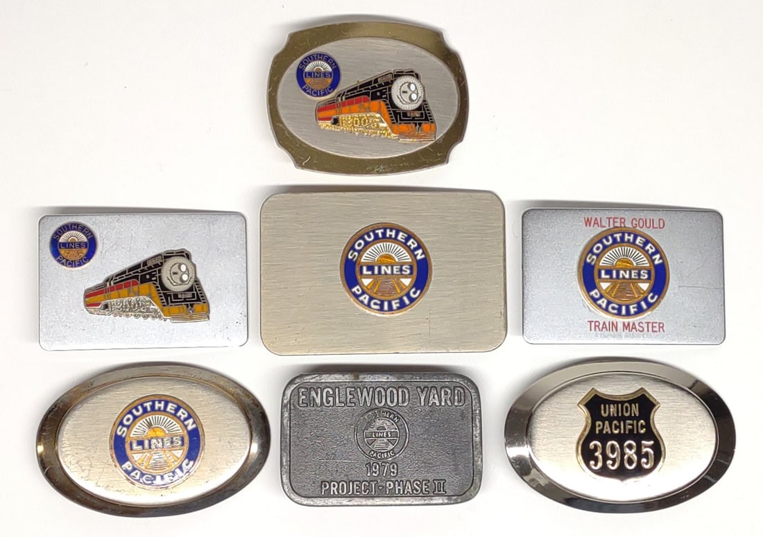 (7) Southern Pacific Railroad Belt Buckles: (7) Vintage belt buckles including (6) Southern Pacific Railroad, and (1) Union Pacific Railroad belt buckle. Largest bucle measures approximately 4" x 2.5".