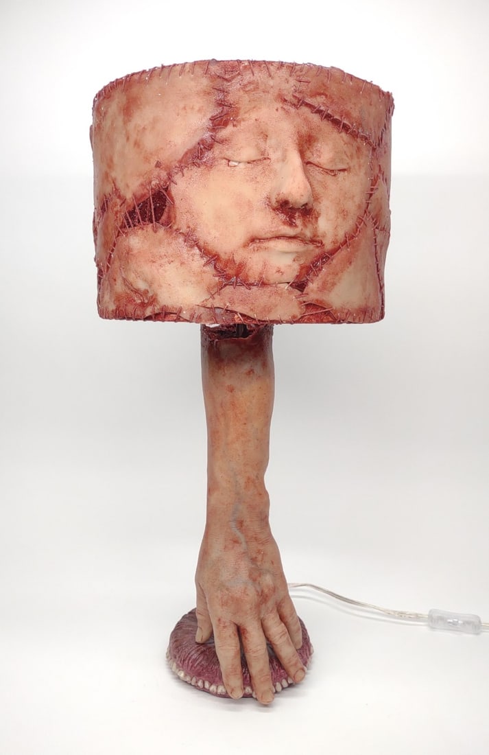 Life Like Silicone Human Skin Lamp: Life like custom hand made human skin lamp with human forearm stem and human top gums and teeth base. Lamp is made from silicone and fitted for standard light bulbs. Lamp measures approximately 23" ta