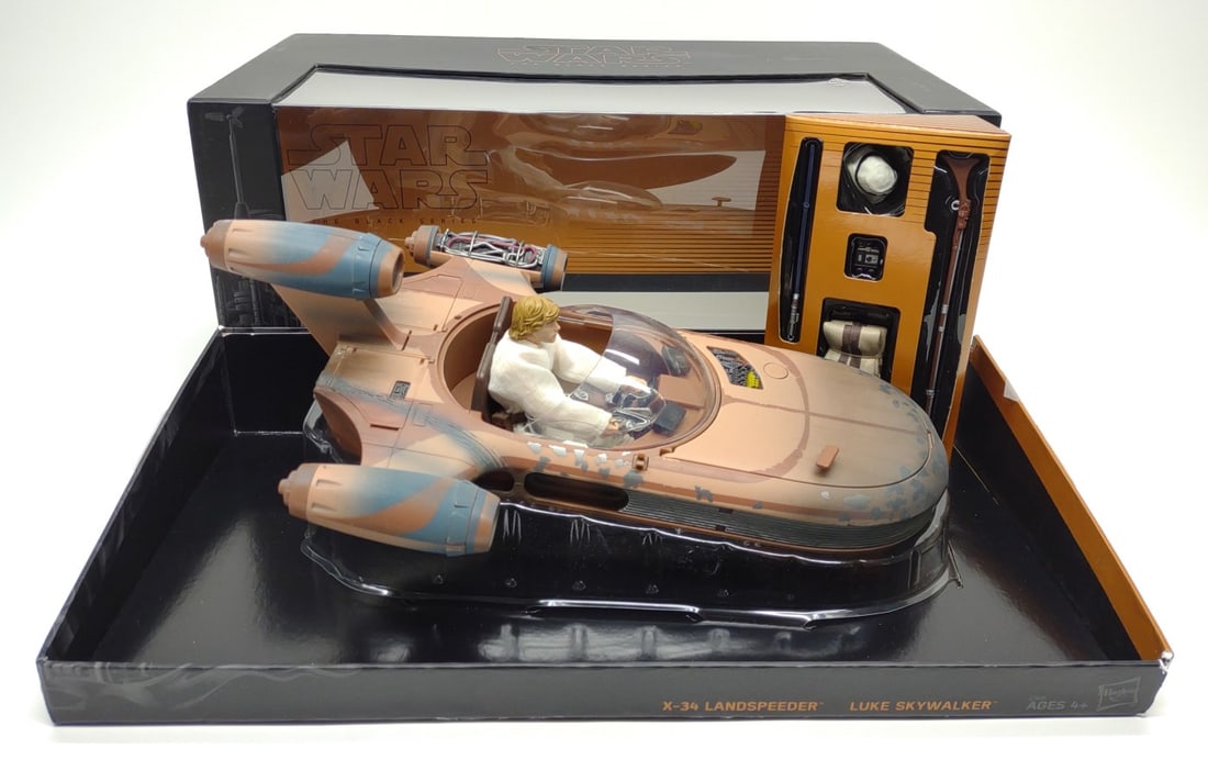 Star Wars Black Series X34 Speeder & Luke Figure: Star Wars Soroscuub Corporation X-34 Land Speeder toy and Luke Skywalker action figure by Hasbro Toys. Toy is in original box. Box measures approximately 16" wide.