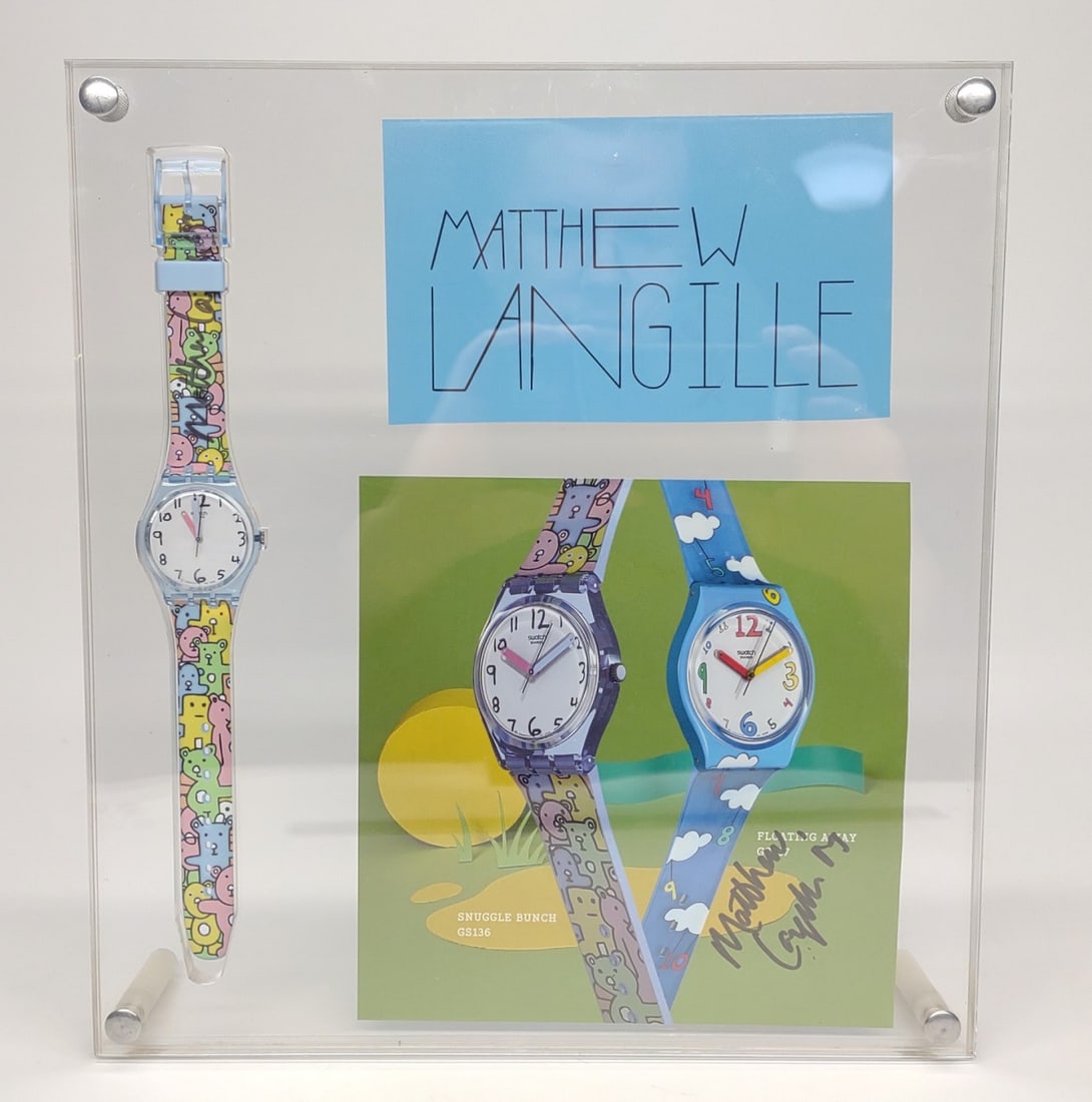 Matthew Langille Signed Swatch GS136 Snuggle Watch: Swatch GS136 "Snuggle Bunch" wrist watch. Swatch is signed by art designer Matthew Langille on band. Swatch watch is in a custom display case including Matthew Langille signed GS136, and GS137 adverti