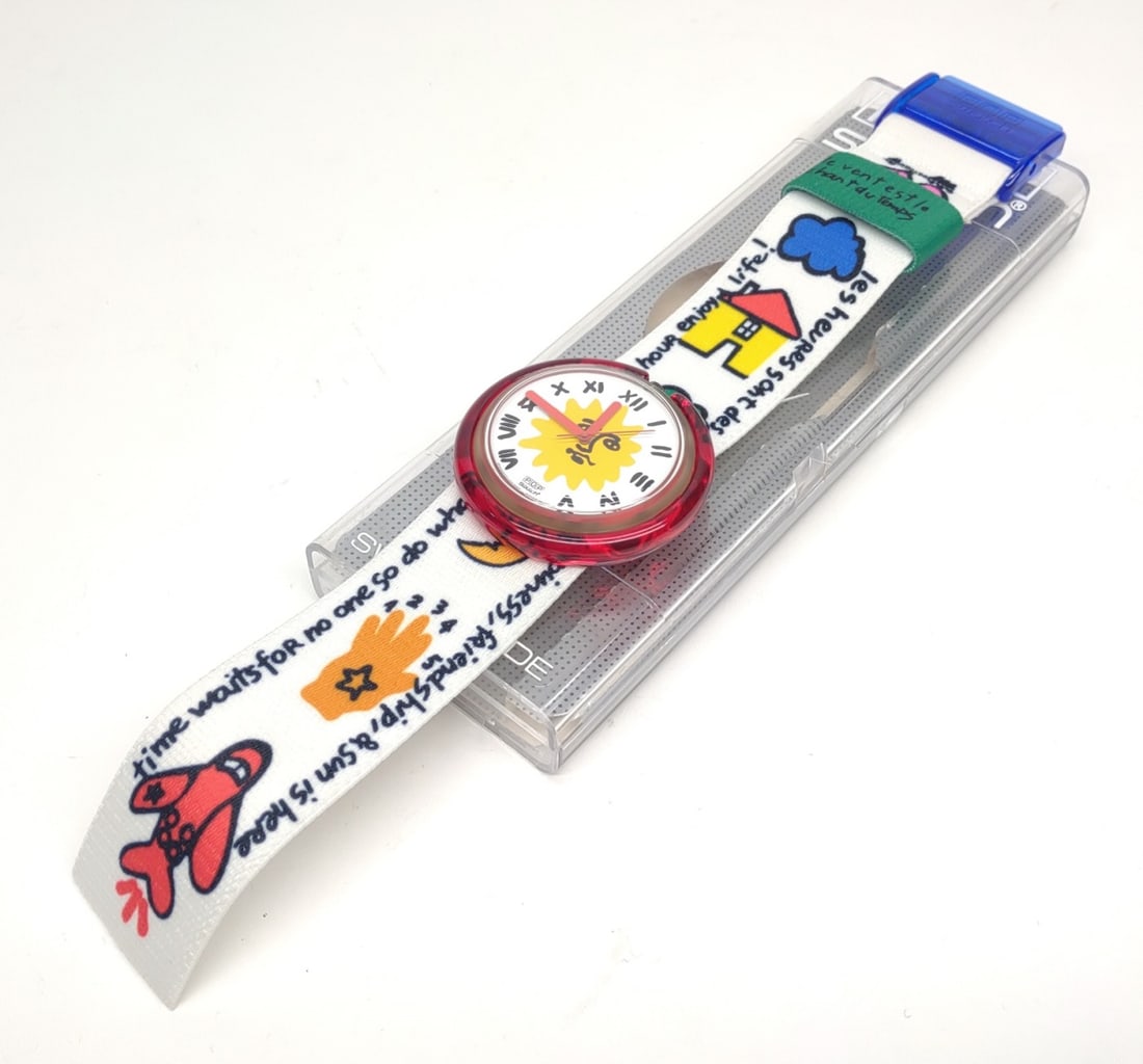 Vintage Pop Swatch PWK190 "Enjoy It" Wrist Watch: Vintage Swatch PWK190 "Enjoy It" Swiss made wrist watch. Movement features the sun with a face and roman numerals. Swatch includes original case. Case measures approximately 7" long. Tested and workin