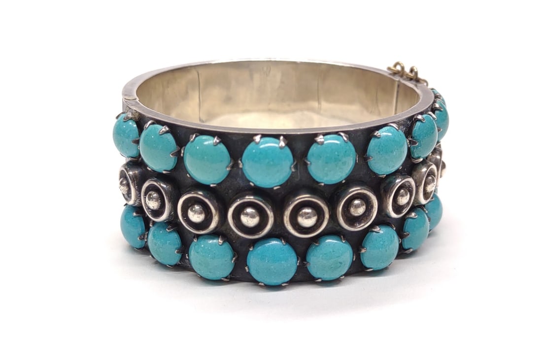 Antonio Reina Turquoise & Sterling Silver Cuff: A vintage Taxco mecican turquoise and sterling silver cuff bracelet by Antonio Reina. Marked "Taxco Mexico 925" with silversmith hallmark "AAR" (Antonio Reina). Features 18 polished round turquoise st