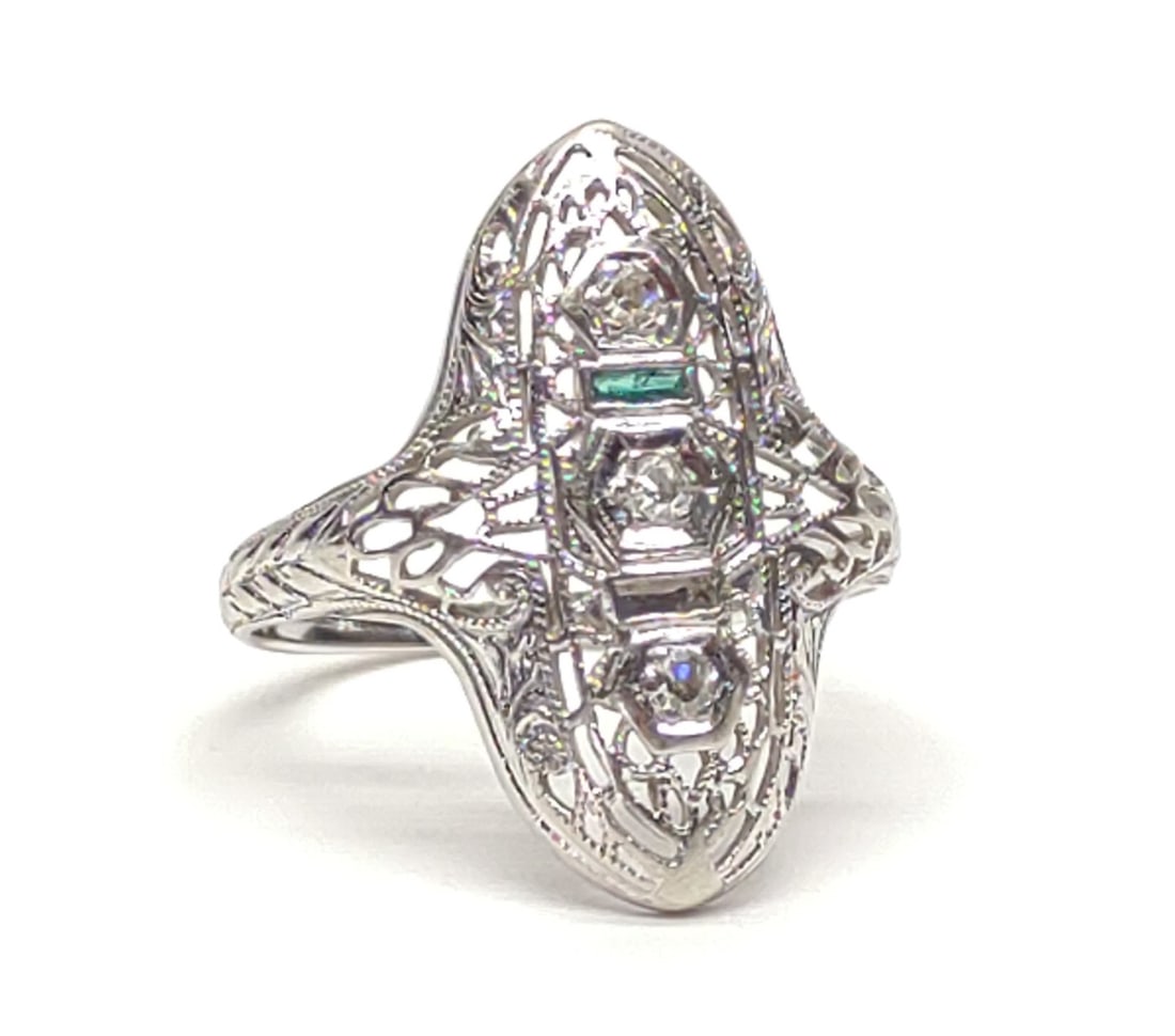 14K W. Gold Art Deco Diamond & Emerald Ring sz 6.5: Vintage, Art Deco, 14 karat white gold, diamond, and emerald filigree ring. Featuring 3 round cut diamonds (0.1 cttw) and single rectangular emerald accent, mounted in filigree setting. Missing 1 emer
