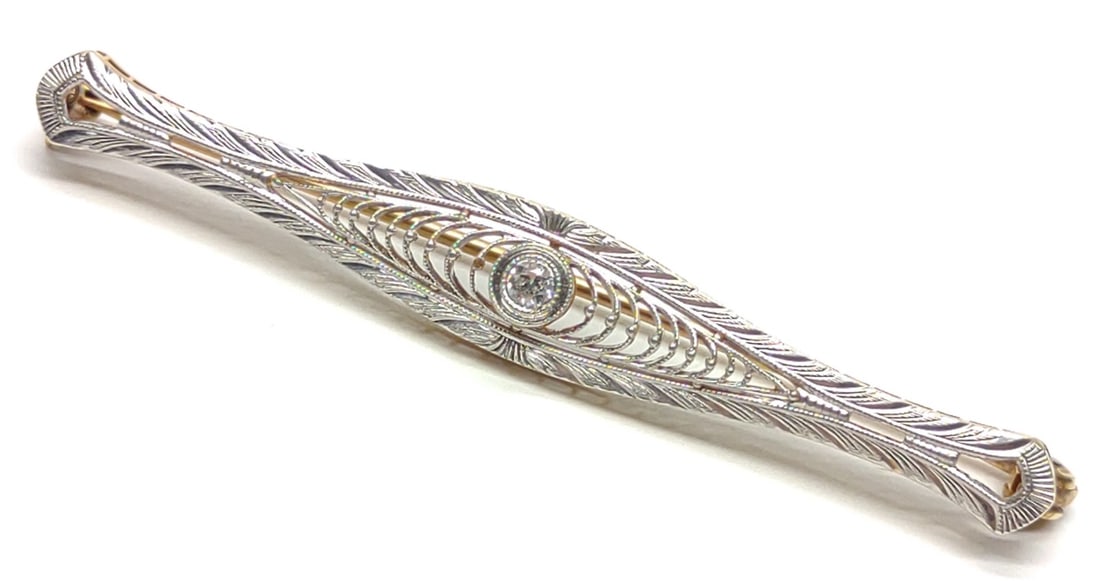 Edwardian 14K Gold & Diamond Filigree Bar Brooch: An antique, Edwardian era, 14 karat yellow and white gold filigree bar pin / brooch with round cut center diamond (0.1 ct). Early 1900s locking C style clasp, marked "14K". Pin and pin arm are both 14