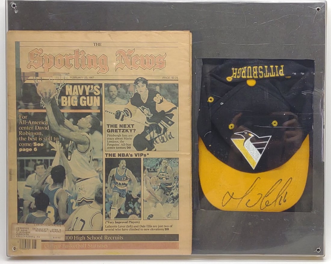 Mario Lemieux Autographed Pittsburgh Penguins Hat: Mario Lemieux signed Pittsburgh Penguins hockey hat and 1987 newspaper, both are autographed by Mario Lemieux. Displayed in acrylic shadowbox frame. Frame measures approx. 20 x 16 1/2 in. SHIPPING OPT