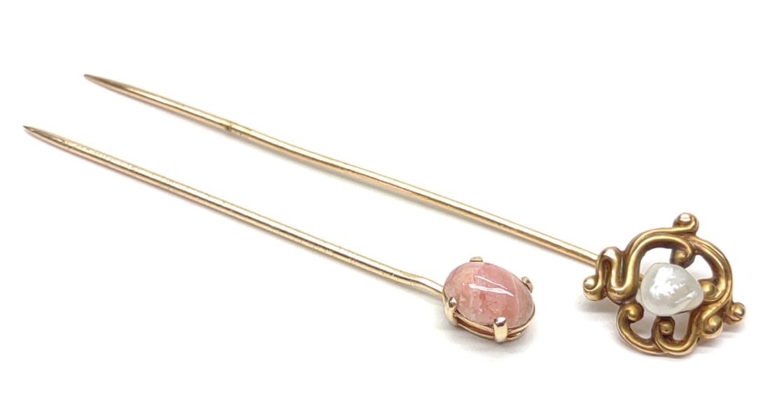 (2) Early 14K Yellow Gold Stickpins: Two antique 14 karat yellow gold stick pins. Includes 14k freshwater pearl stickpin (marked 14K), and 14k stickpin with pink marbleized stone (unmarked). Both pin tops and stems are of 14k gold. Both