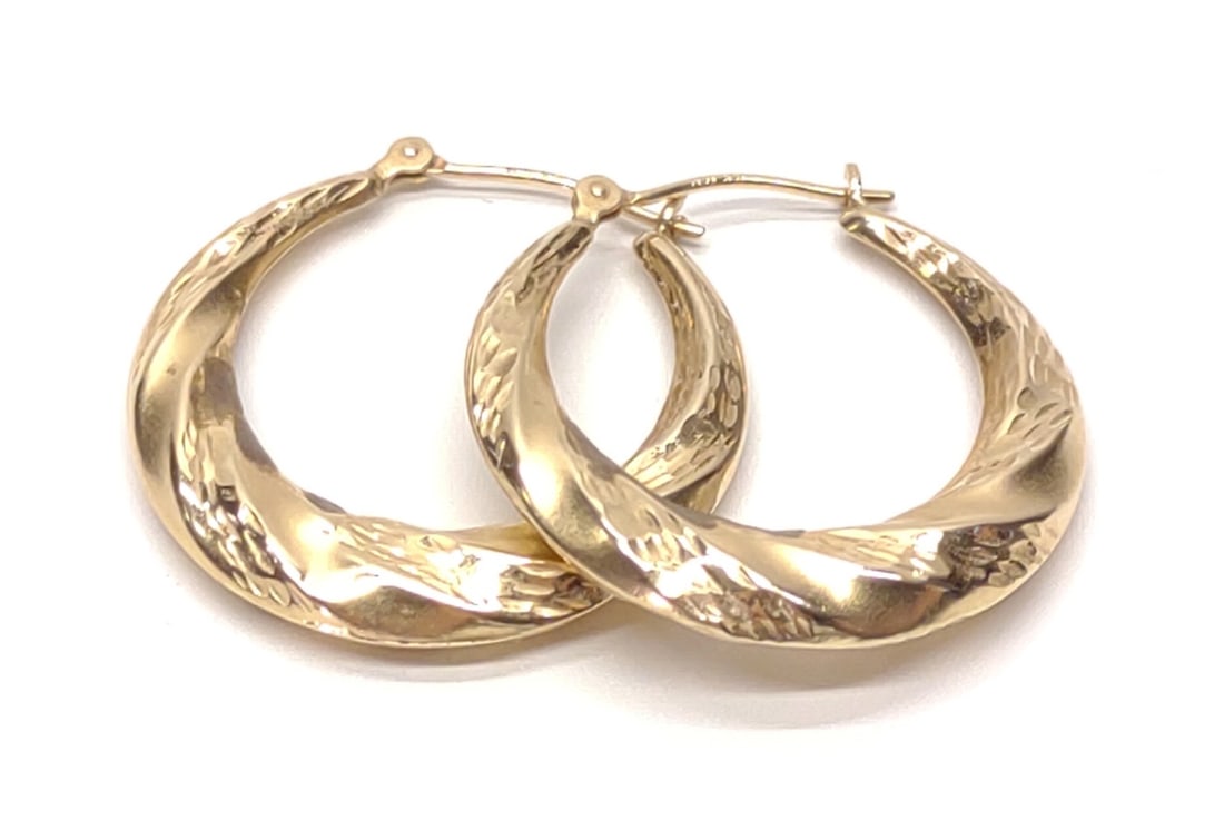 14K Yellow Gold Twisted Hoop Earrings: A pair of 14 karat yellow gold twisted hoop earrings. Both posts are marked "14K JCM". Has been tested for gold purity. Total weight: 1.58 grams. SHIPPING OPTIONS AVAILABLE: UPS 'Pack & Ship' or LiveS