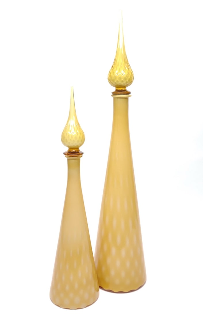 Pr of MCM Genie Bottle Decanters w/ Stoppers: Pair of yellow and white mid century modern glass genie bottle decanters. Includes both stoppers. Good condition, no chips or cracks. Largest measures approx. 25 3/8" tall and 5 1/2 in. diameter. SHIP