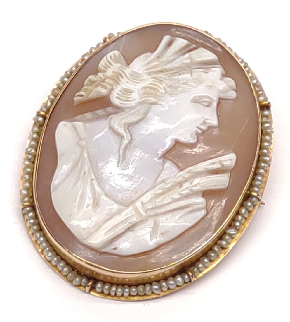 Antique 10K Gold Carved Cameo Brooch / Pendant: An antique, early 1900s, 10 karat yellow gold carved cameo brooch / pendant with strung seed pearl border. Marked "10K" on top of safety C clasp. Has been tested for gold purity. Total weight: 7.52 gr