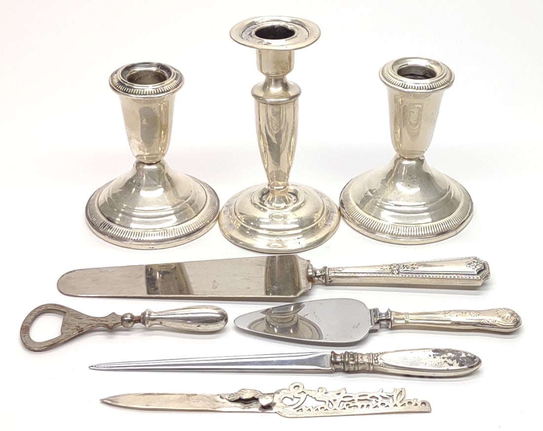 8 Sterling Silver Weighted Candlesticks & Flatware: 8 Sterling silver weighted candlesticks and sterling handled pie servers, letter opener, bookmark, and bottle opener. All pieces are marked "Sterling" and have been tested for purity. Bookmark is soli