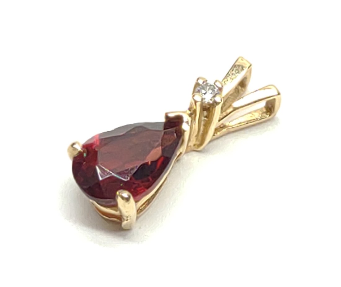 14K Gold Pear Garnet (1.15ct) & Diamond Pendant: Antique, 14 karat yellow gold, garnet and diamond necklace pendant. Pear cut garnet, 1.15 carat with round diamond accent. Unmarked. Has been tested for gold purity and stones. Total weight: 0.64 gram