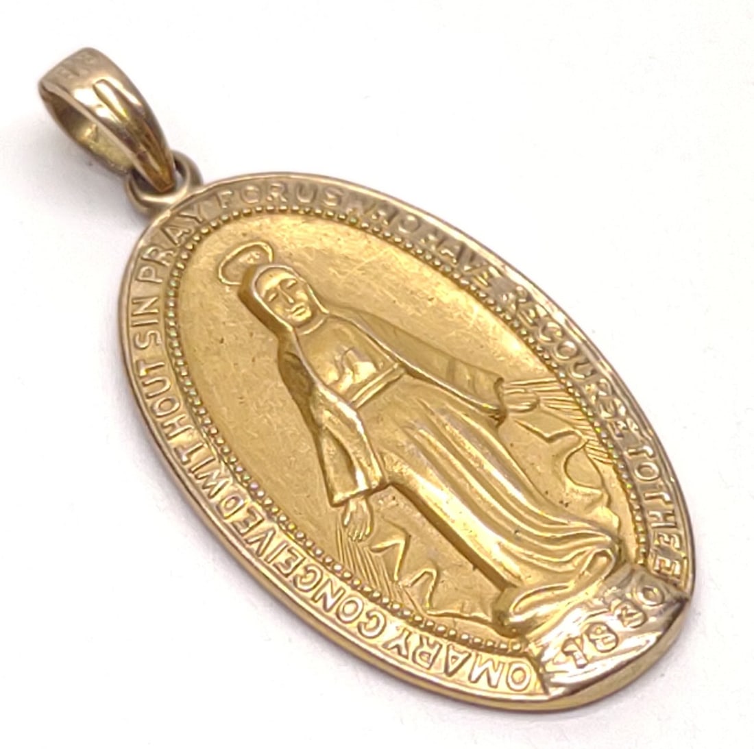 10K Gold Virgin Mary Miraculous Medal Pendant: 10 karat yellow gold religious necklace pendant of Virgin Mary, miraculous medal. Backside is marked "10K". Has been tested for gold purity. Total weight: 2.24 grams SHIPPING OPTIONS AVAILABLE: UPS