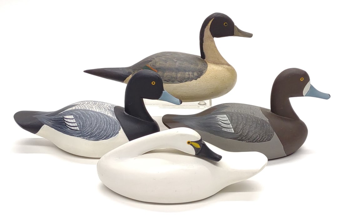4 Roger & Jess Urie Miniature Duck & Swan Decoys: Four Roger and Jess Urie (Rock Hall, MD) miniature carved duck decoys. Includes Roger Urie preening tundra swan, pair of Roger Urie bluebill ducks, and Jess Urie pintail. All are signed on underside o