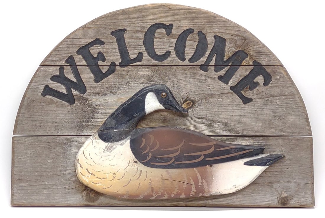 Carved Canada Goose Welcome Wooded Sign: Hand carved and painted canada goose decoy style welcome sign. Measures approx. 24 x 16 1/2 x 2 in. SHIPPING OPTIONS AVAILABLE: UPS 'Pack & Ship' or LiveShipping. In-house shipping available for INTER