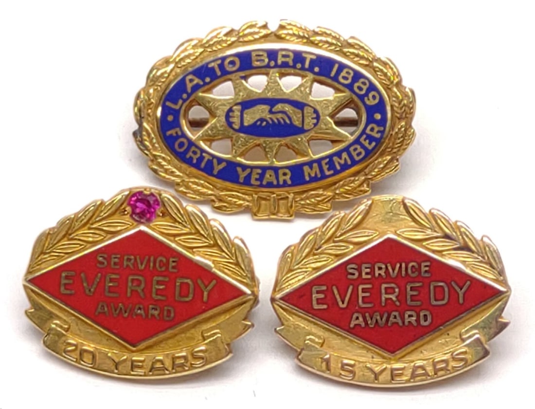 (3) 14K & 10K Gold Lapel Award Pins: Group of three vintage 14 karat and 10 karat gold service pins. Includes 14K Everedy service award pin with ruby (2.30g), 10K Everedy service award pin (2.10g), and 10k LA to BRT railroad pin (1.65g).