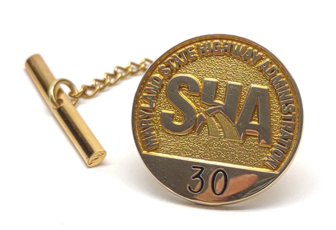 10K Gold Maryland State Highway Lapel Pin: 10 karat yellow gold Maryland State Highway Administration lapel pin by Terry Berry. Marked "10K" on backside. Has been tested for gold purity. Total weight (excluding pin backing): 3.69 grams. SHIPPI