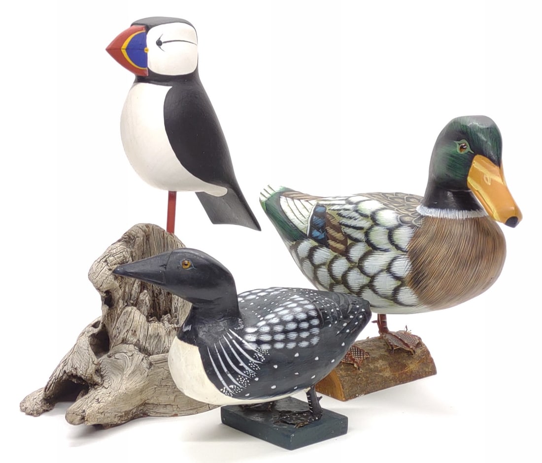 (3) Mallard, Puffin & Loon Wooden Bird Sculptures: Group of three wooden painted bird sculptures. Includes loon standing on wooden block (unsigned), wooden mallard duck standing on log (unsigned), and hand carved puffin birdon driftwood base by Chris