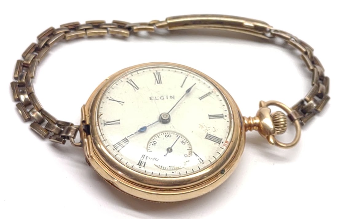 1910 14K Gold Elgin Model 2 Pocket Watch (repair): An antique, circa 1910, 14 karat yellow gold Elgin model 2 pocket watch with attached Hadley wrist watch band. Inner watch case is marked "Warranted to Assay 14K" with "B.W.C. Co" makers mark. Elgin m