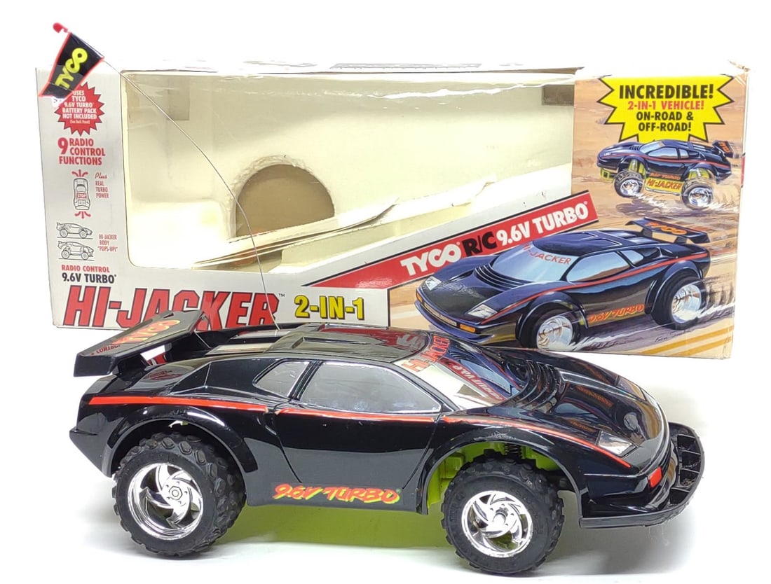 Tyco RC 9.6V Turbo Hi-Jacker Toy Car w/ Box (read): Vintage 1993 Tyco Hi-Jacker 9.6V Turbo r/c car toy with box. Includes Hi-Jacker r/c car, controller, two 9.6V batteries, original box, and manual. Controller, steering, and spring jacks work. Rear whe