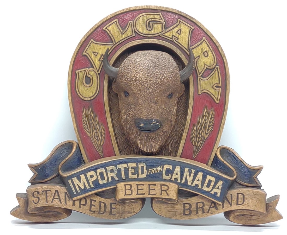 Calgary Stampede Canadian Beer 3D Sign 17x14": Vintage three dimensional Calgary Stampede canadian beer mounted bison advertising bar sign. Sign reads "Calgary Imported From Canada Stampede Beer Brand". Sign measures approx. 17 1/2 x 14 1/2 in. SH