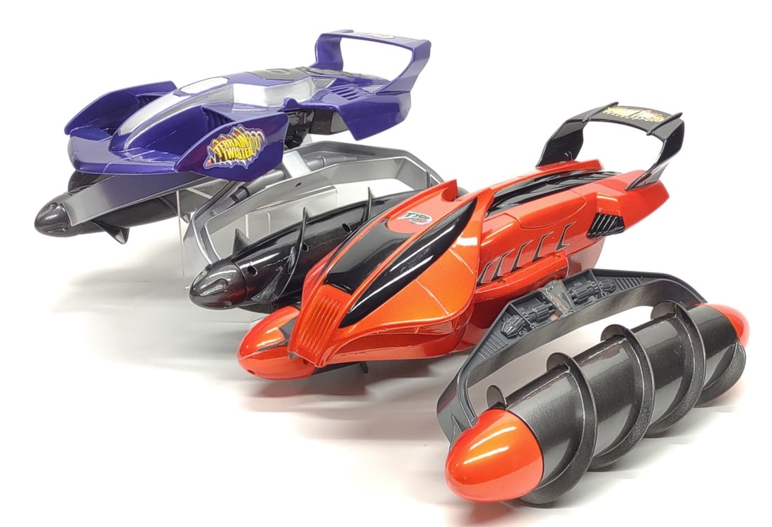 2 Pre-Production Tyco R/C Terrain Twister Toy Cars: 2 Vintage Tyco R/C pre-production design sample Terrain Twister r/c toy vehicles. Includes unrealeased original 1st design purple test shot, and 2nd final production orange version test shot. Both are
