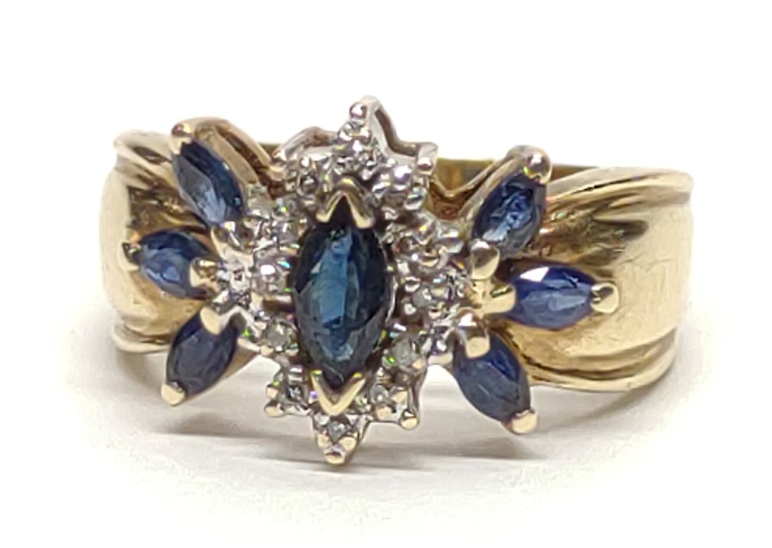 10K Gold Marquise Sapphire & Diamond Cluster Ring: Vintage 10 karat yellow gold marquise blue sapphire and diamond cluster ring. Features 7 marquise cut sapphires, and 12 round cut diamonds. Inner band is marked "10K TS". Has been tested for gold